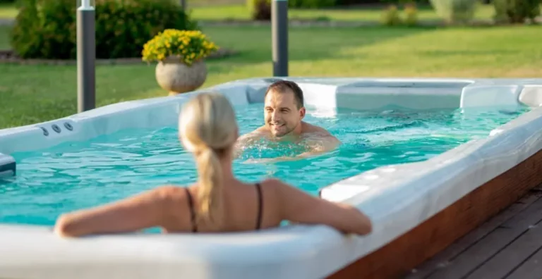 Picture of a couple enjoying their swim spa after learning about swim spa vs. pool costs.